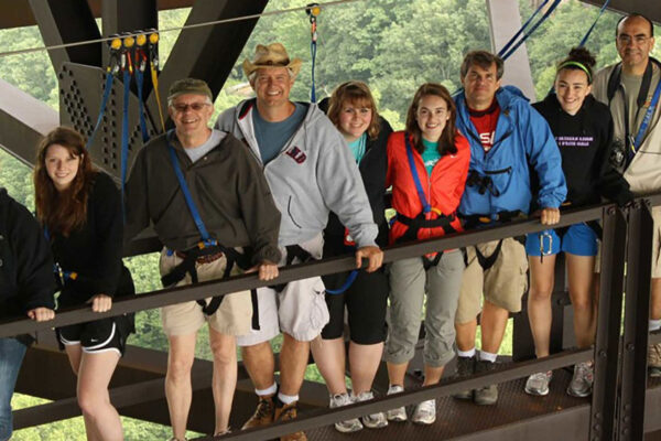 a group smiling on a bridgewalk