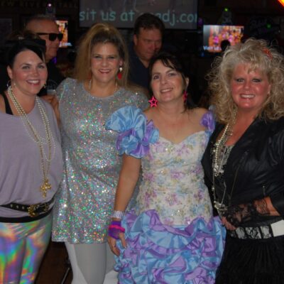 a group of women dressed up in 80s gear