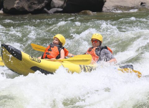 a father and son paddling in a duckie