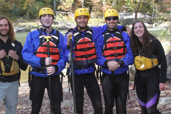 rafters pose with two guides during their whitewater trip at River Expeditions West Virginia