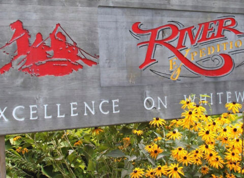 the river expeditions logo on the sign in front of the building