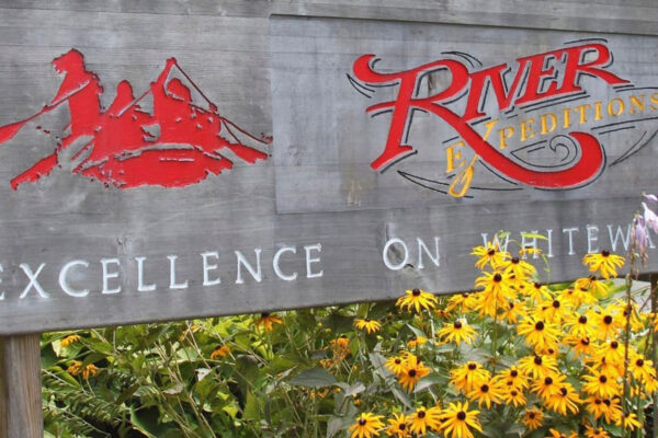 the river expeditions logo on the sign in front of the building