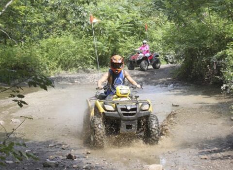 a group of 5 people on ATVs on a trail