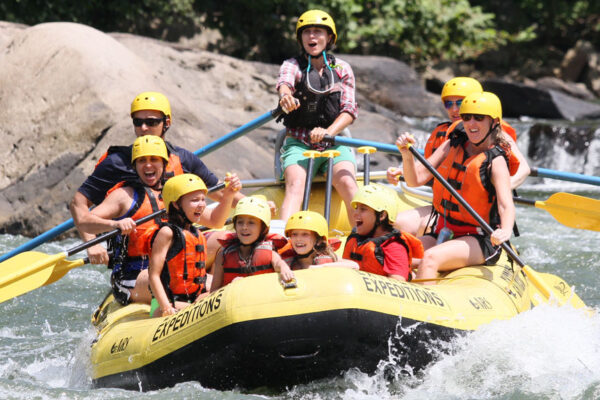 raft guide, young kids, and adults enjoy whitewater rafting River Expeditions West Virginia