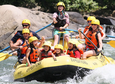 raft guide, young kids, and adults enjoy whitewater rafting River Expeditions West Virginia