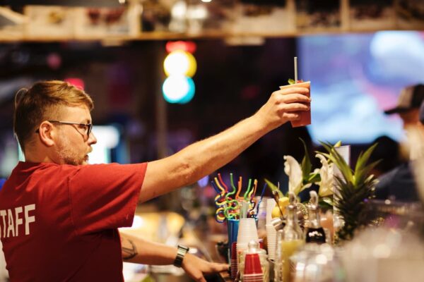 a bartender holding up a bloody mary