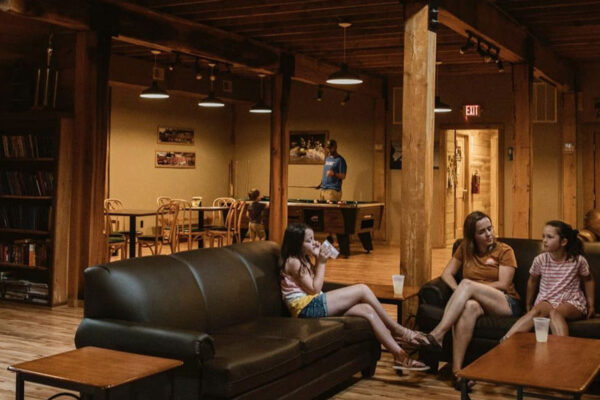 a family sitting on the couch in the lodge