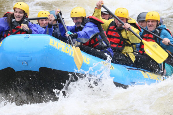 whitewater rafters work together on their two day Gauley River trip River Expeditions West Virginia