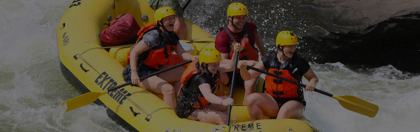 a group of rafters approaching a rapid with smiles