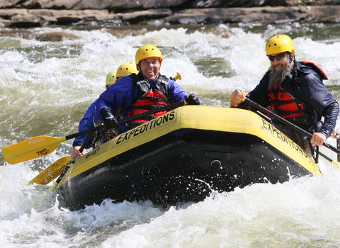 group of male friends enjoy their Gauley River rafting trip River Expeditions West Virginia