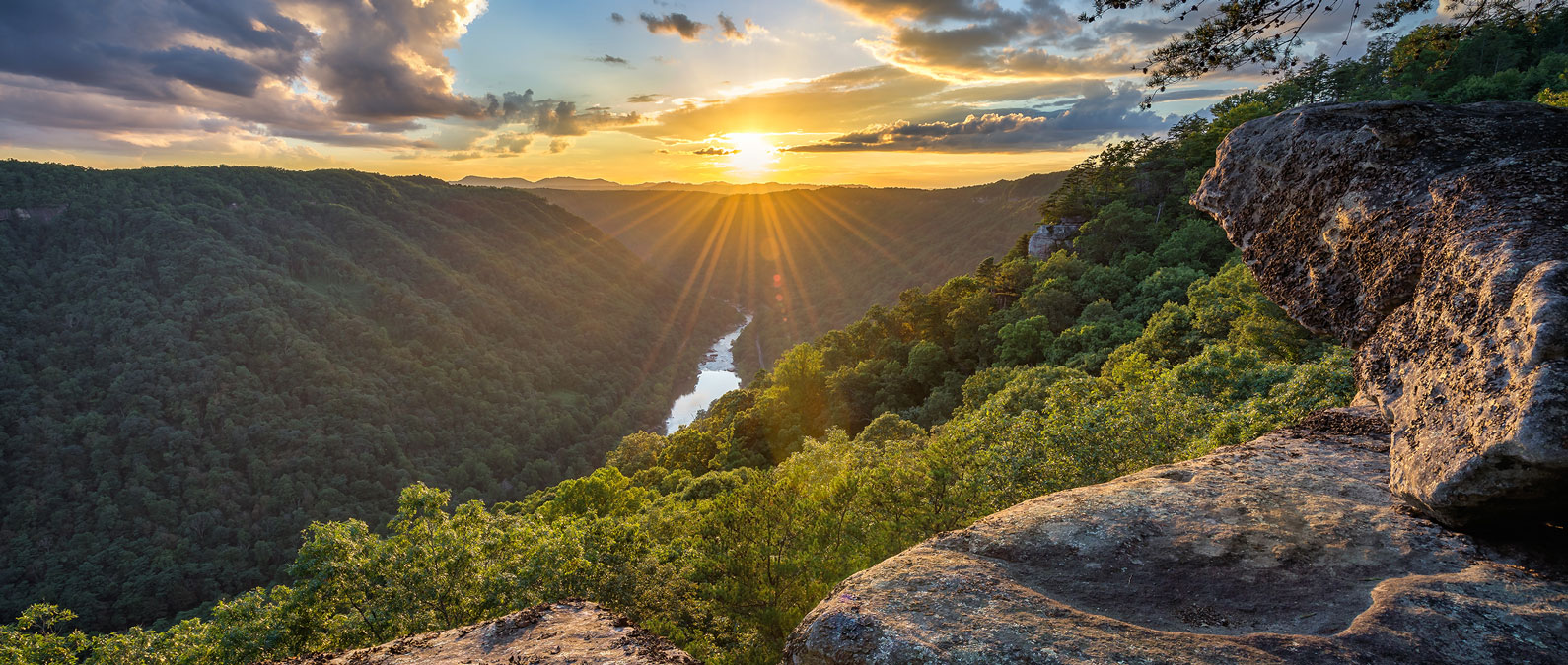 sunset view in the hills with the river below River Expeditions West Virginia