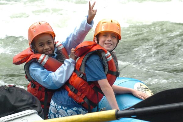 two kids in a raft smiling